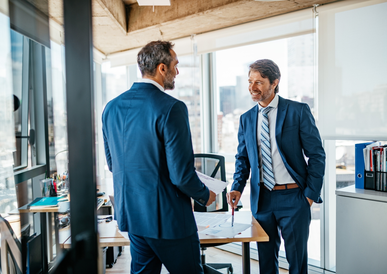 two businessmen shaking talking