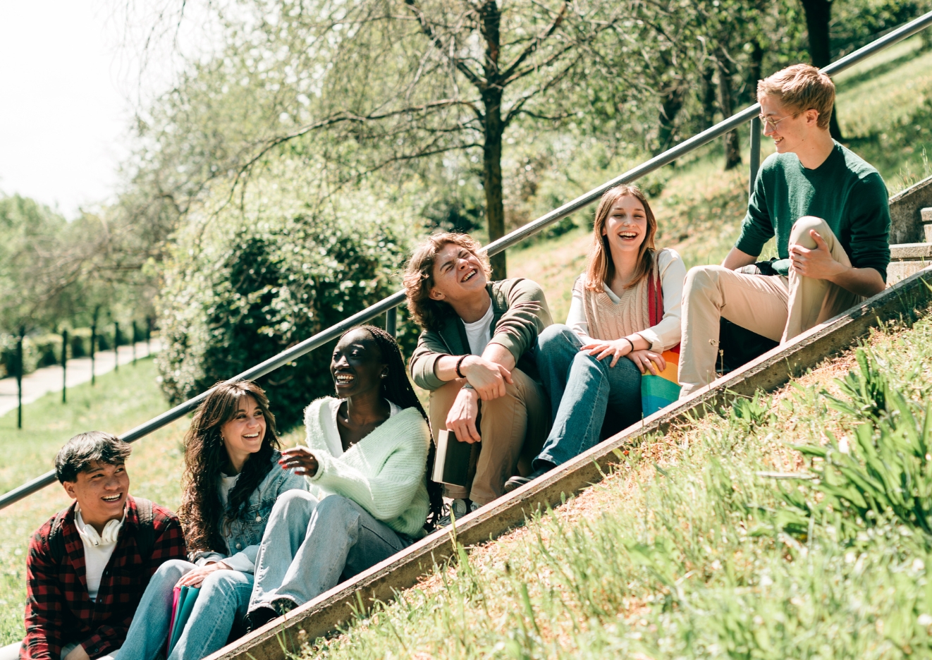 exchange students sitting on a staircase outdoors