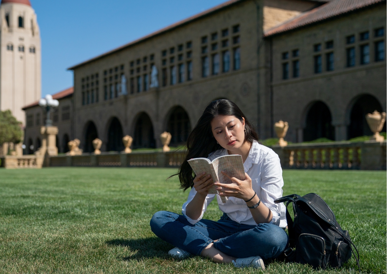 student reading on campus