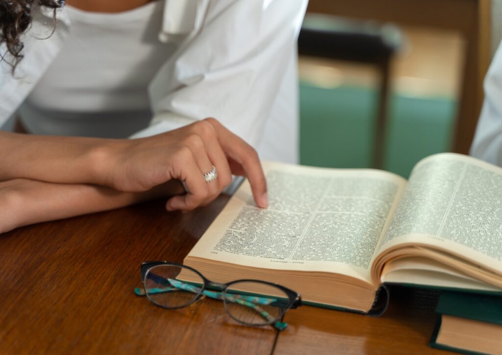 Person pointing at a glossary of words