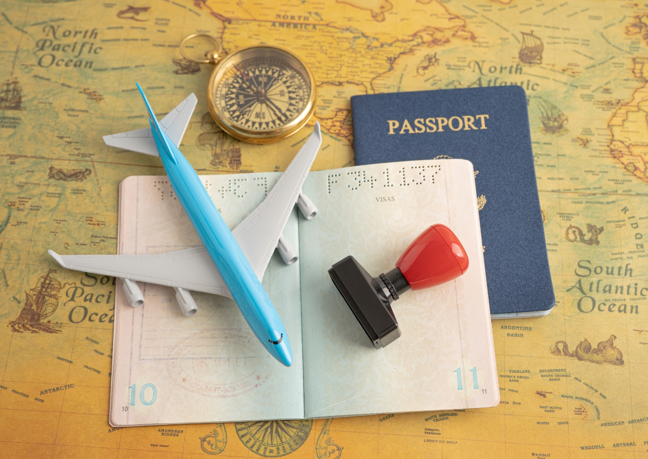 passport placed on top of a world map