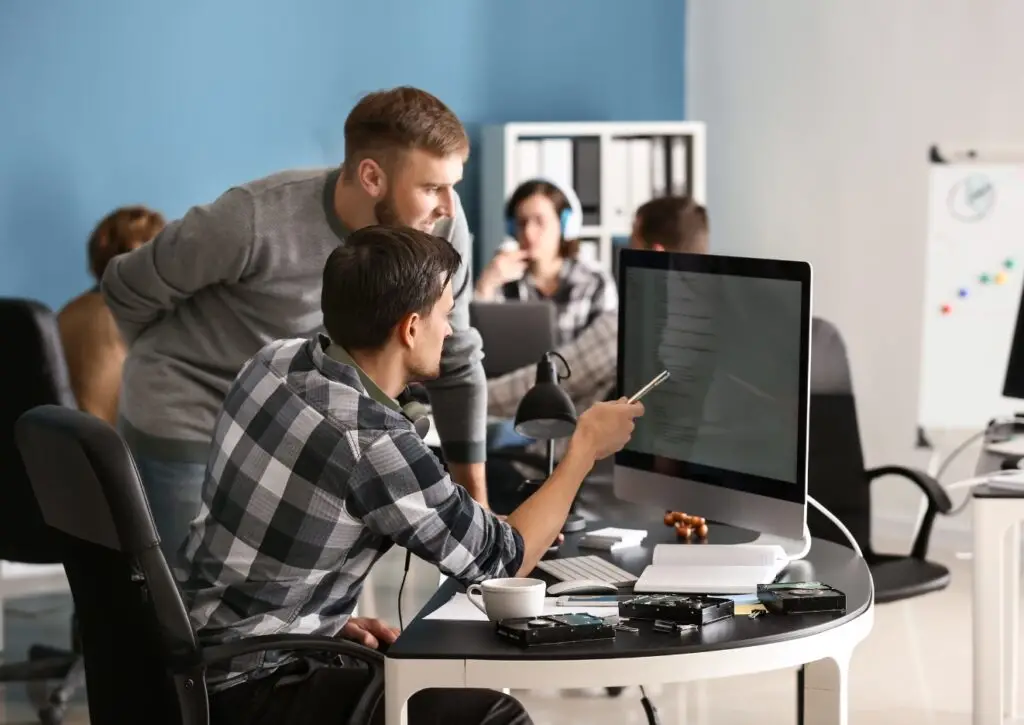 Two people working on a computer